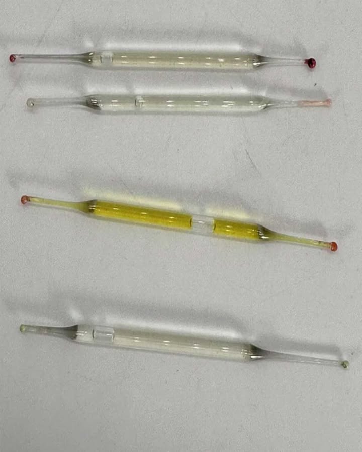 What are these? Found under a bathroom cabinet during renovations – small glass tubes, 5 cm long, filled with liquid. Any ideas?