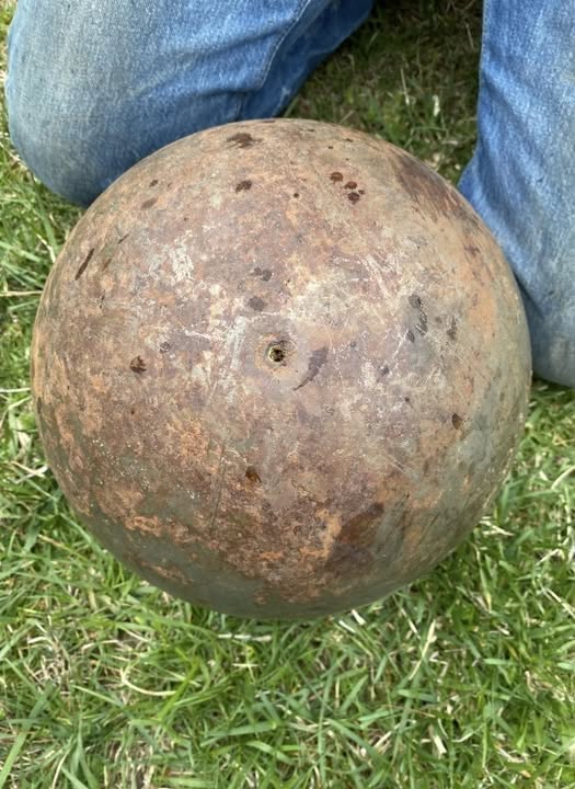 Found a giant ~150 lb. steel ball in a creek near my house. It has tiny boreholes and leaked black liquid when we rolled it around. Any ideas?